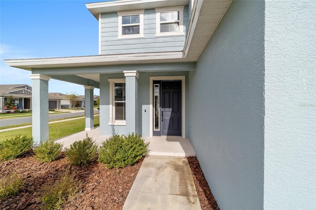 entrance to property featuring a porch