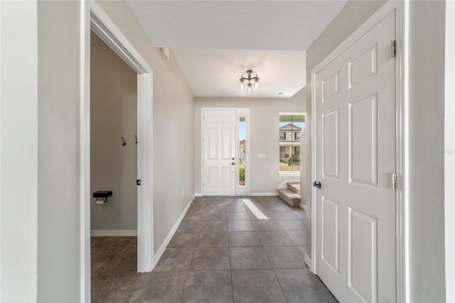 tiled entrance foyer with a textured ceiling