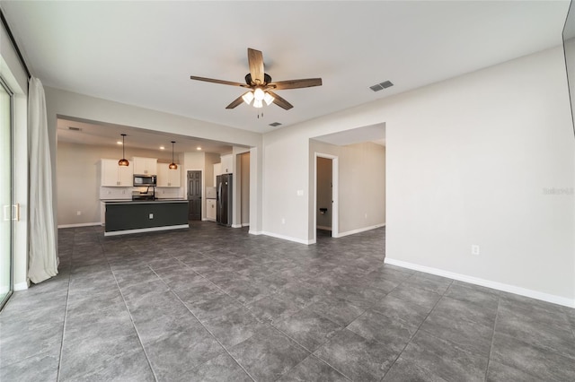 unfurnished living room featuring ceiling fan