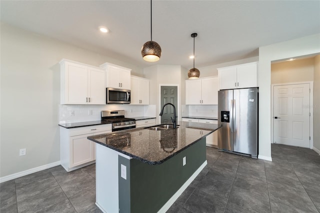 kitchen with white cabinets, sink, an island with sink, and stainless steel appliances