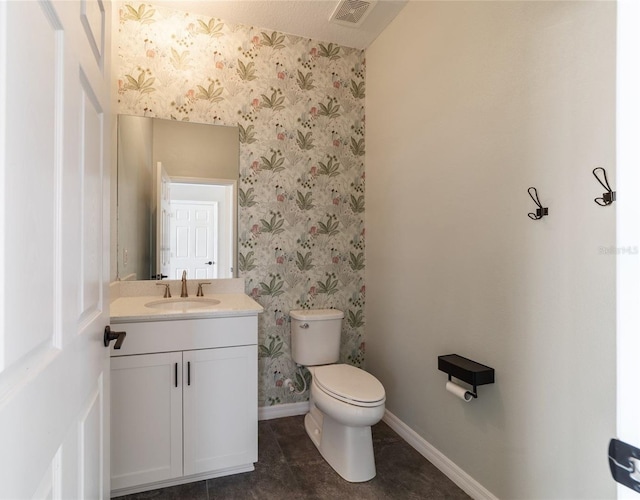 bathroom with tile patterned flooring, vanity, and toilet