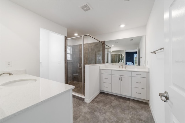 bathroom featuring vanity and an enclosed shower