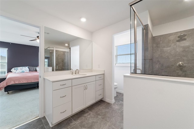 bathroom with tile patterned floors, toilet, vanity, ceiling fan, and walk in shower