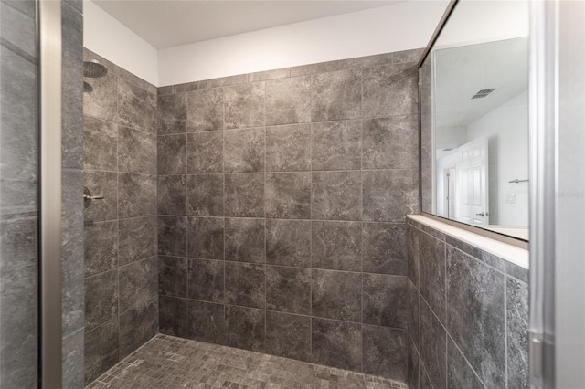 bathroom with tiled shower