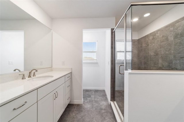 bathroom with vanity, tile patterned floors, and a shower with door