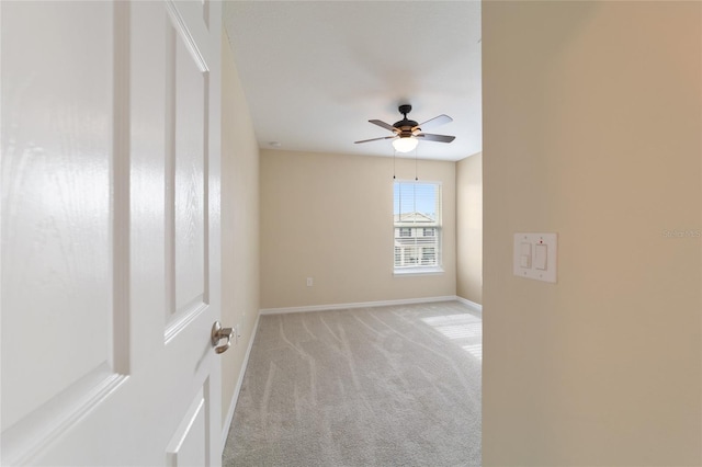 carpeted spare room with ceiling fan