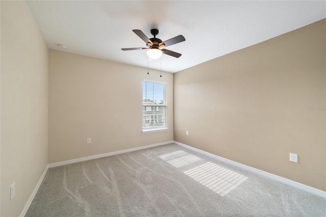 unfurnished room featuring light colored carpet and ceiling fan