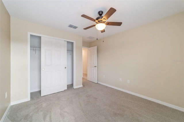 unfurnished bedroom with a closet, light carpet, and ceiling fan