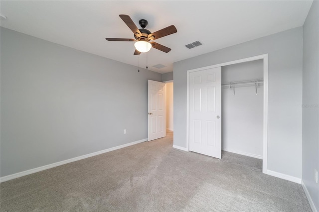 unfurnished bedroom with a closet, light carpet, and ceiling fan