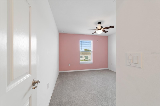 unfurnished room featuring light carpet and ceiling fan