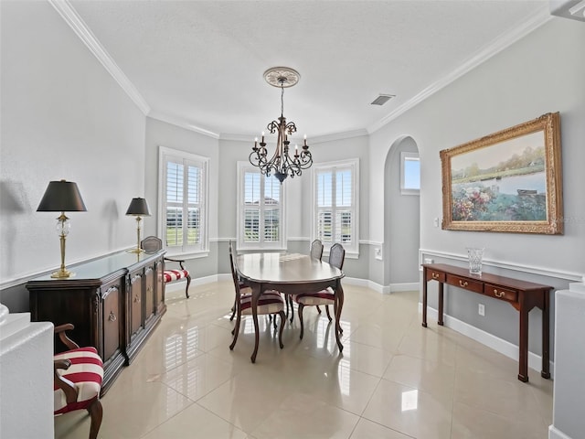 dining room with plenty of natural light, light tile patterned floors, and crown molding