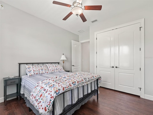 bedroom featuring a closet, ceiling fan, and dark hardwood / wood-style flooring