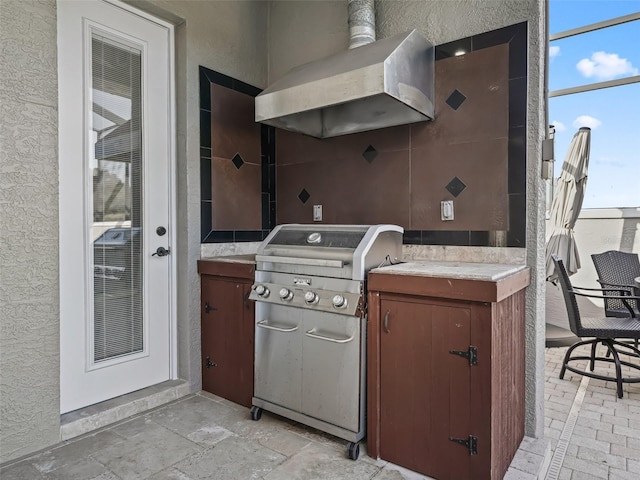 view of patio with area for grilling and a grill