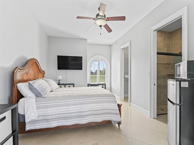 tiled bedroom featuring ceiling fan, fridge, and ensuite bath