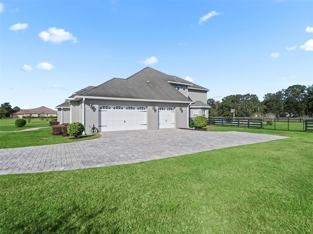 view of side of property featuring a lawn and a garage