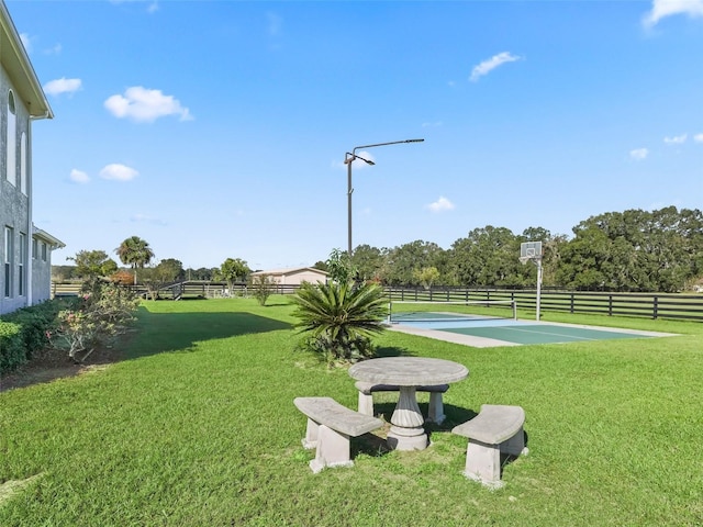 view of community featuring a yard and a rural view