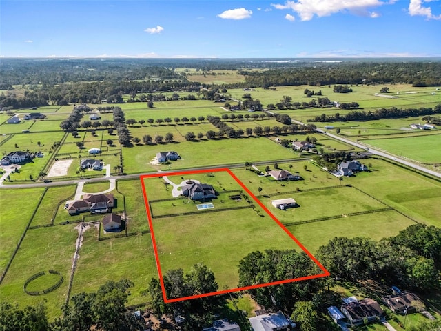 birds eye view of property with a rural view