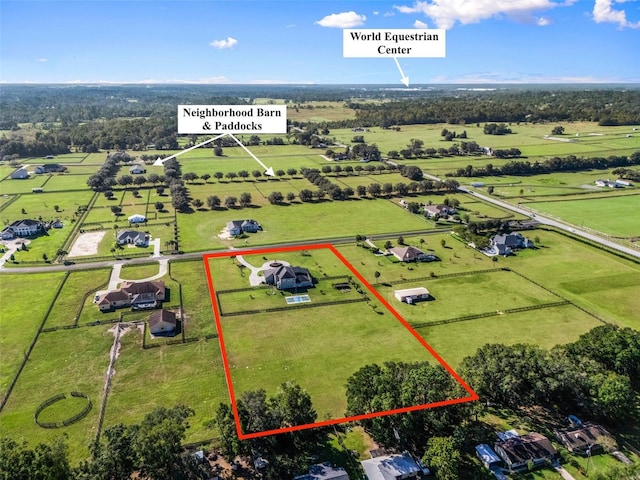 birds eye view of property with a rural view