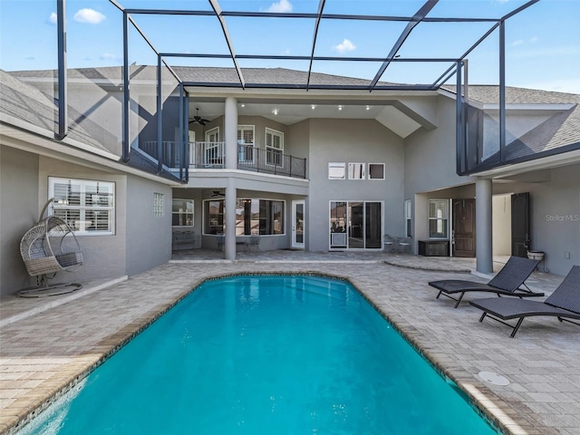 back of property featuring a balcony, a lanai, a patio area, and ceiling fan