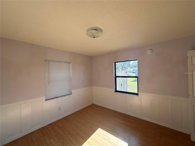 spare room with wood-type flooring