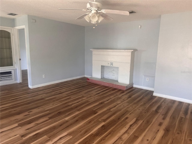 unfurnished living room with a textured ceiling, dark hardwood / wood-style flooring, and ceiling fan