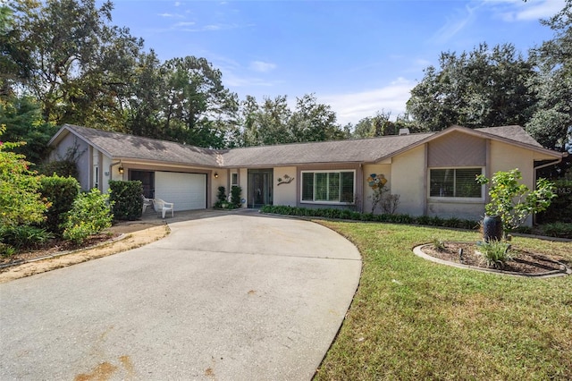 single story home with a front yard and a garage