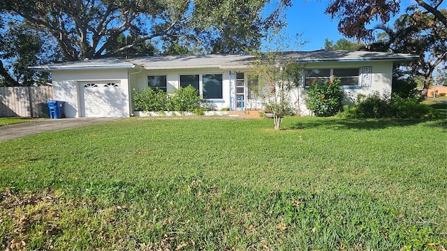 ranch-style house featuring a garage and a front yard