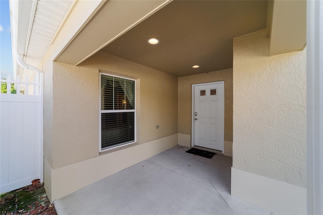 view of exterior entry featuring a patio