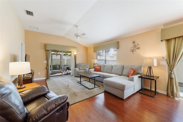 living room with lofted ceiling, dark wood-type flooring, ceiling fan, and a healthy amount of sunlight