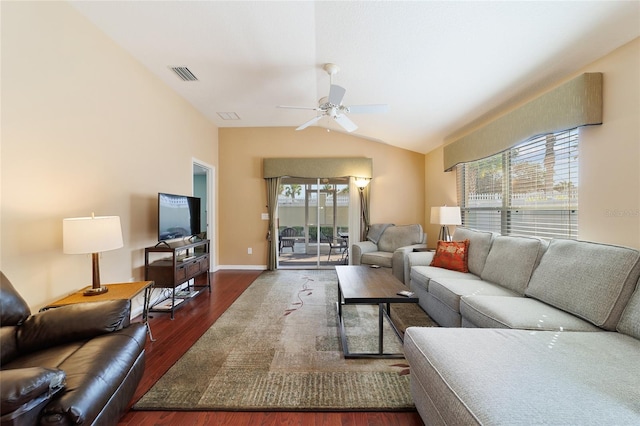 living room with ceiling fan, dark wood-type flooring, a healthy amount of sunlight, and vaulted ceiling