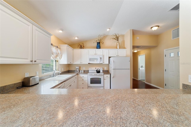 kitchen featuring vaulted ceiling, sink, white cabinets, and white appliances