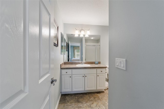 bathroom featuring vanity and a textured ceiling