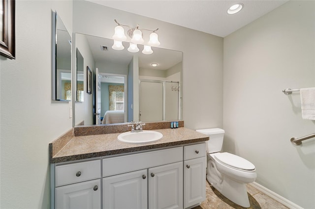 bathroom featuring vanity, toilet, and a shower with door