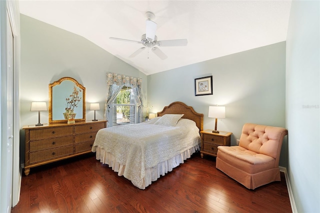 bedroom featuring dark hardwood / wood-style floors, ceiling fan, a closet, and vaulted ceiling