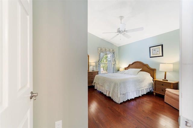 bedroom with ceiling fan, dark wood-type flooring, and vaulted ceiling