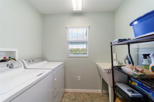 laundry room featuring a textured ceiling and washing machine and clothes dryer