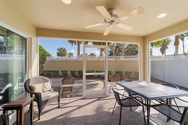 sunroom featuring ceiling fan and a healthy amount of sunlight