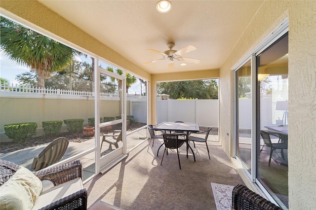 sunroom / solarium featuring ceiling fan