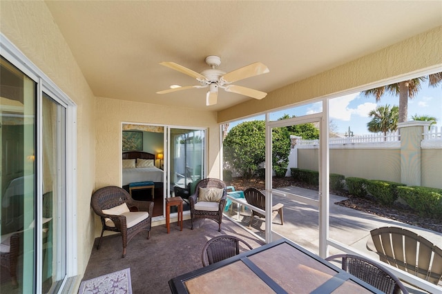 sunroom / solarium featuring ceiling fan