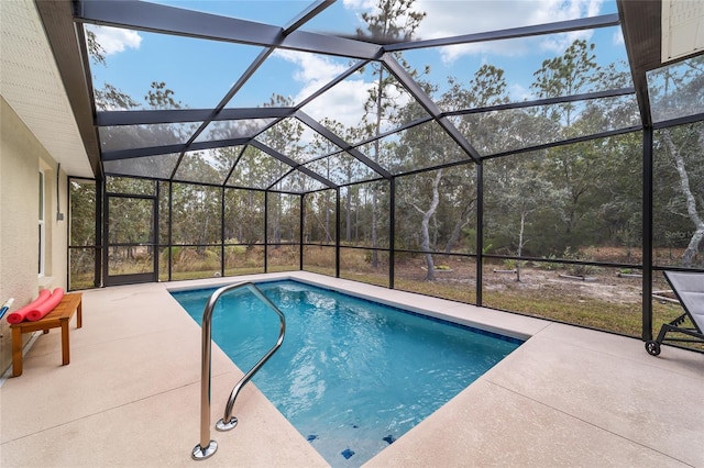 view of swimming pool with a patio and a lanai