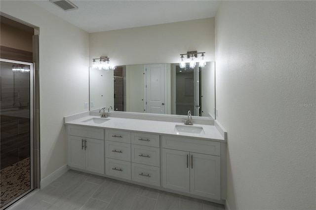 bathroom featuring walk in shower and vanity