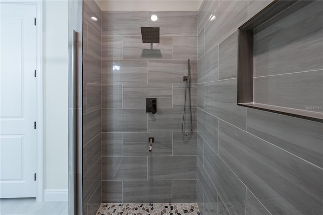 bathroom with a tile shower