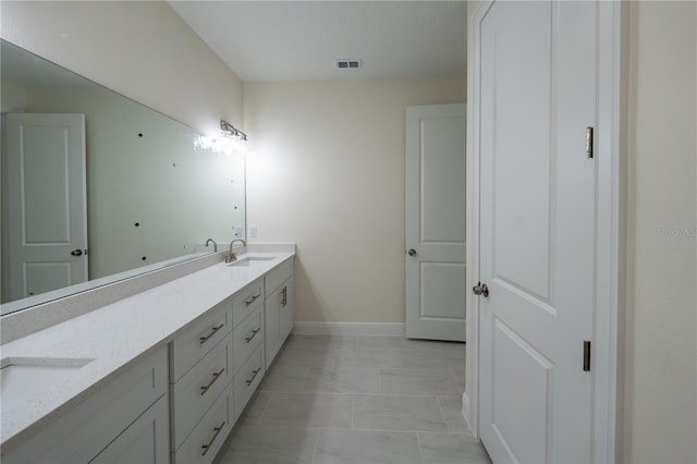 bathroom with vanity and tile patterned floors