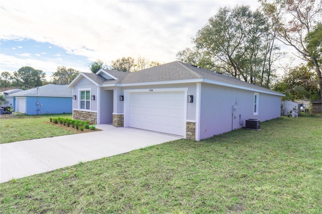 ranch-style house featuring a front yard, central air condition unit, and a garage