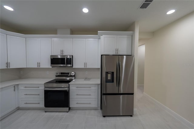 kitchen featuring white cabinets and appliances with stainless steel finishes