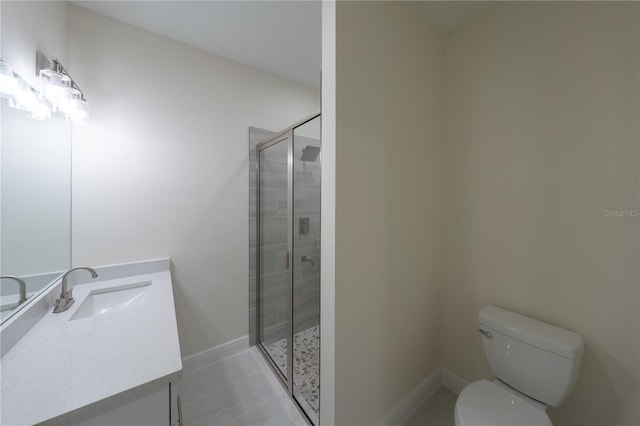 bathroom featuring tile patterned flooring, toilet, vanity, and walk in shower