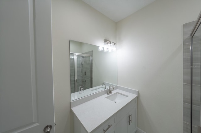 bathroom with a shower with door and vanity