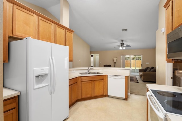 3107 NE 24th Pl, Ocala, FL 34470 - kitchen featuring white appliances, vaulted ceiling, a sink, a peninsula, and a ceiling fan