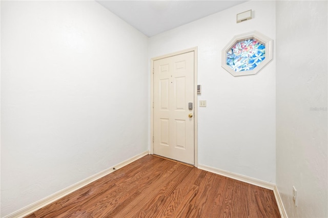 doorway to outside with wood-type flooring