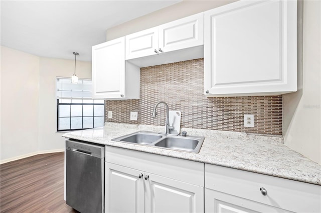 kitchen with pendant lighting, dishwasher, white cabinetry, and sink